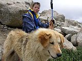 Tibet Kailash 09 Kora 14 Peter and our Kora Dog Pete and I rested as we reached the foot of the pass. In the foreground is a dog that walked the kora with us. He was very gentle and protective. Pete named him Koalae.